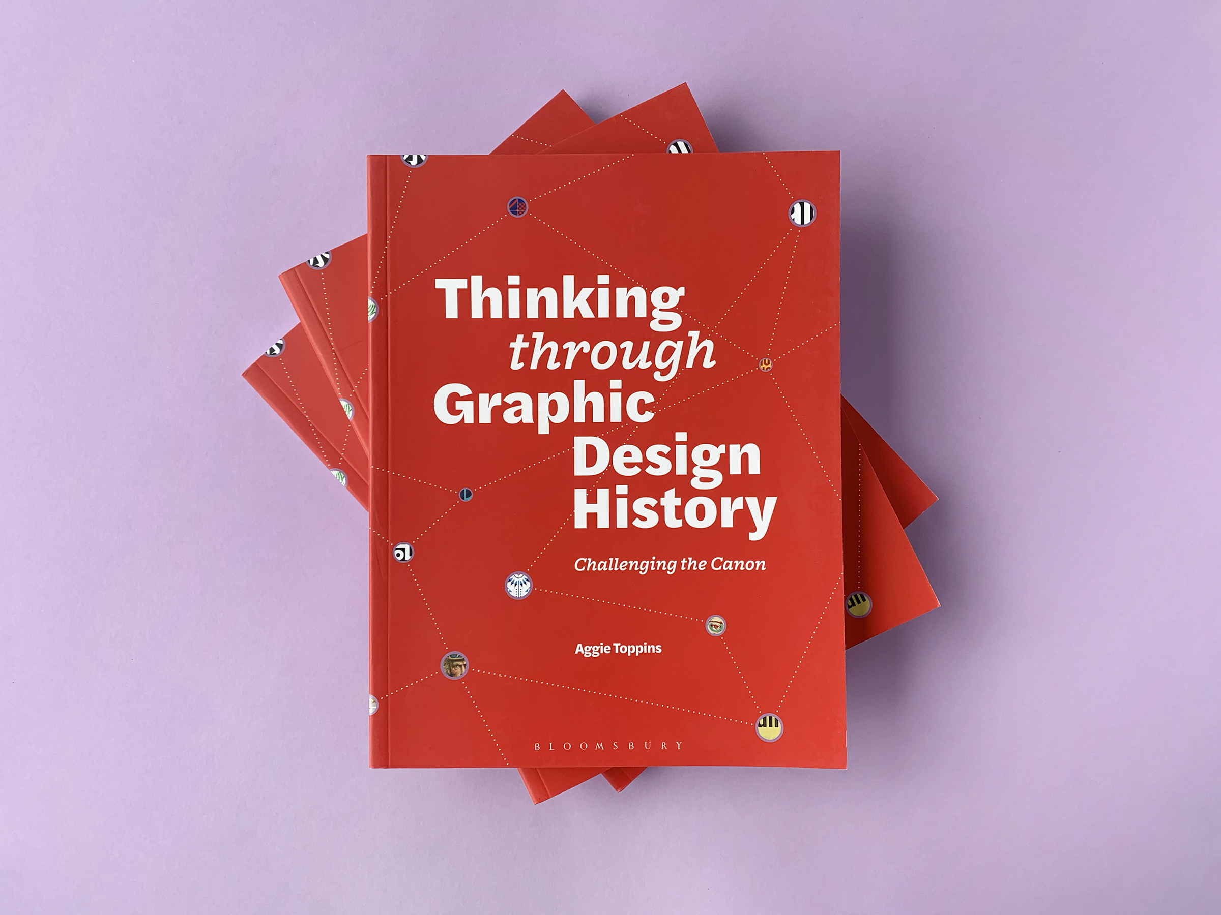 a stack of red books on a light purple background